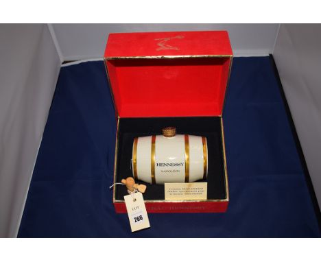 A presentation bottle of Hennessy Napoleon Cognac, the bottle in the shape of a Limoges barrel, in presentation box.