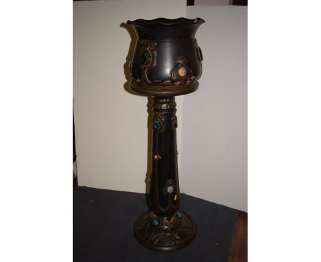 A Bretby jardiniere on stand, in Arts & Crafts design, with Ruskin style enamel spade and circular shaped mounts, the jardini