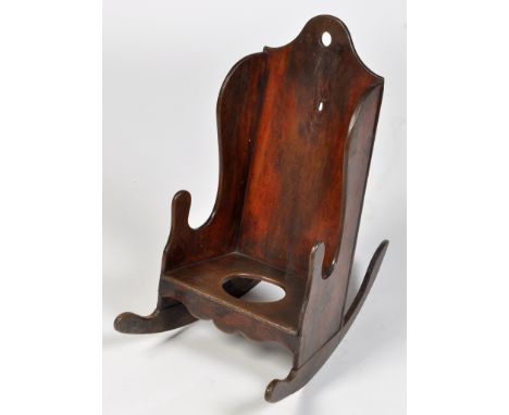 A child's early 18th Century oak rocking chair, the shaped back and sides above seat with commode cut-out, 41 x 66 x 70cms (1
