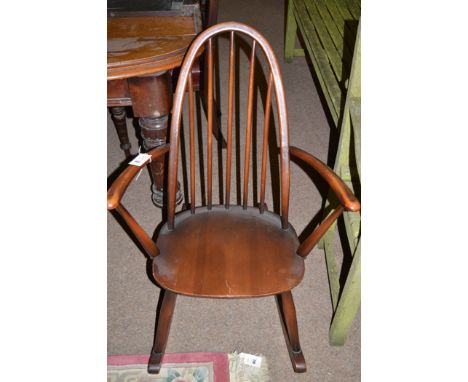 An Ercol style ash spindle back rocking chair.