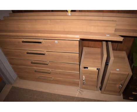 A bedroom suite comprising: a double bed; a modern laminate chest of five drawers, 118cm wide; and a pair of bedside cabinets