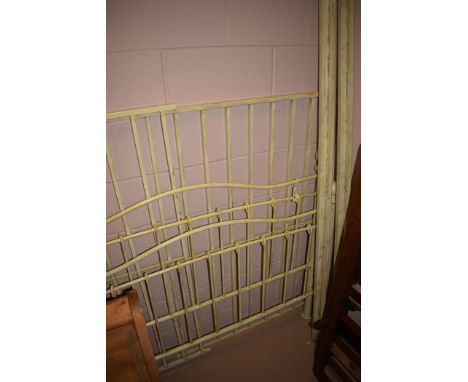 A modern pale green painted metal double bed.