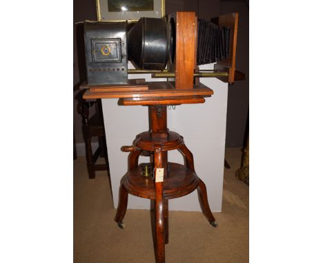 A late 19th Century magic lantern, the black coloured metal case fitted 8in. diameter lens, adjustable bellows to front, stan