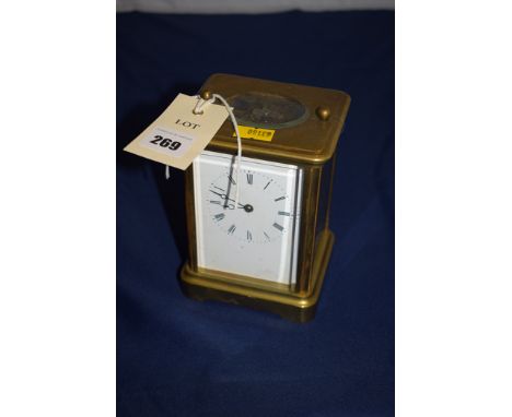 An early 20th Century brass carriage clock, open escapement, enamel roman dial, with striking movement.
