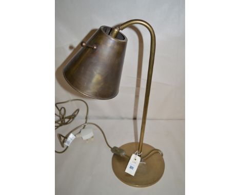 A reproduction brass table lamp with flared shade, by Jim Lawrence.