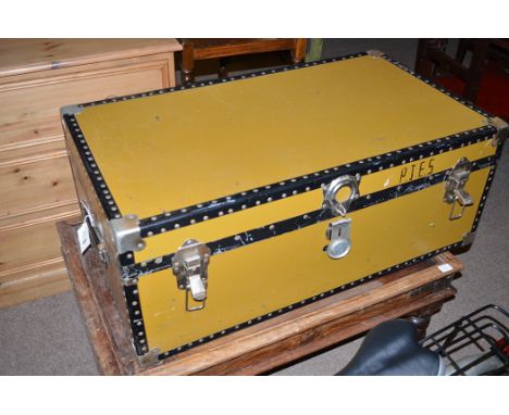 An early 20th Century mustard coloured travelling trunk with metal and leather mounts.