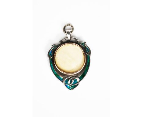 A rare Liberty &amp; Co silver and enamel pendant locket designed by Archibald Knox, shield shape, cast in low relief with Ce