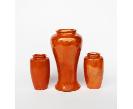 A large Ruskin Pottery baluster vase designed by William Howson-Taylor, dated 1913, covered in an orange lustre glaze, and a 