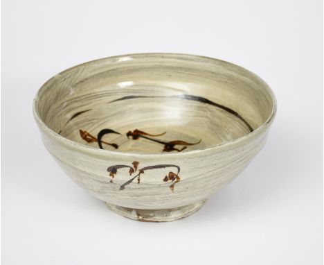 Jim Malone (born 1946) an Ainstable Pottery stoneware bowl, on shallow foot, painted with simple grass motif to outside and w