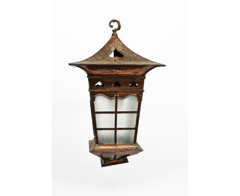 A large patinated copper hall lantern, tapering square section with lover light, overhanging mantle and tapering top, with ba