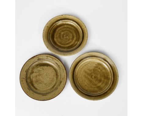 Richard Batterham (1936-2021) a stoneware tea plate, covered with an ash glaze, and two others unsigned 18.5cm. diam. (3) Pro