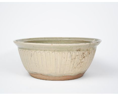 Reuben Batterham (born 1967) a large stoneware planter, tapering cylindrical form with cut flutes, glazed to the foot in pale