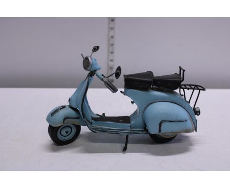 A metal model of a Vespa scooter 