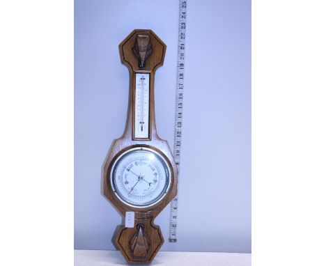 A wooden case barometer.  No postage 