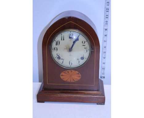 A antique wooden cased mantel clock with key and pendulum 