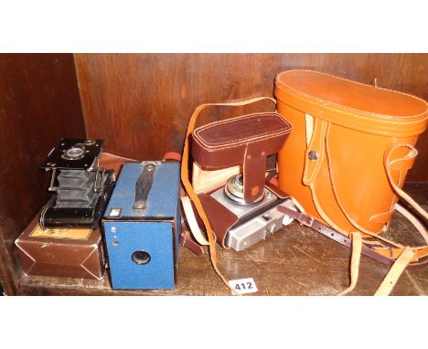 Vest Pocket Autographic Kodak Camera and case, a blue No. 2 Brownie and a pair of binoculars
