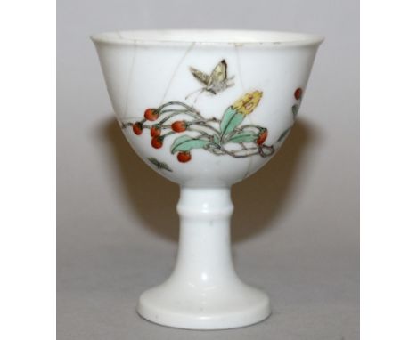 A CHINESE FAMILLE VERTE PORCELAIN STEM CUP, the sides decorated with butterflies and an extended foliate spray, the inside of