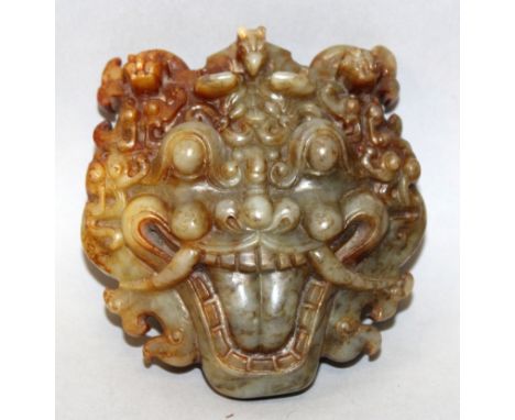 A GOOD QUALITY CHINESE JADE CARVING OF A DEMONIC MASK, the features well defined, the stone of predominantly green tone with 