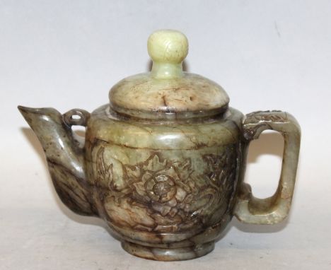 A GOOD EARLY 20TH CENTURY CHINESE JADE TEAPOT & COVER, the sides carved with panels of extended foliage, the stone of predomi