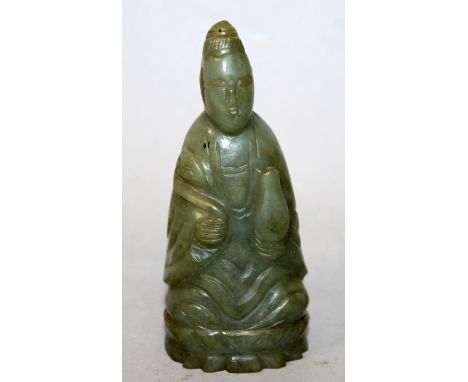 A SMALL EARLY 20TH CENTURY CHINESE DARK CELADON JADE FIGURE OF GUANYIN, seated on a lotus plinth and bearing a ruyi sceptre a