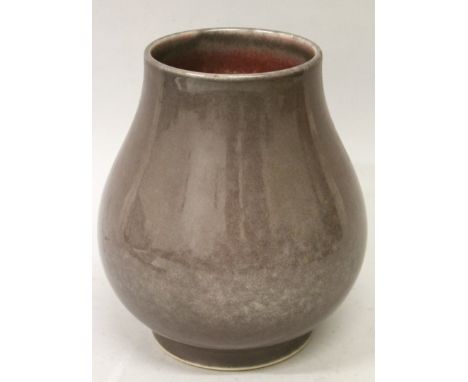 A CHINESE MONOCHROME PORCELAIN VASE, the bulbous pear-form body applied with a slightly mottled brown-aubergine glaze, the ba