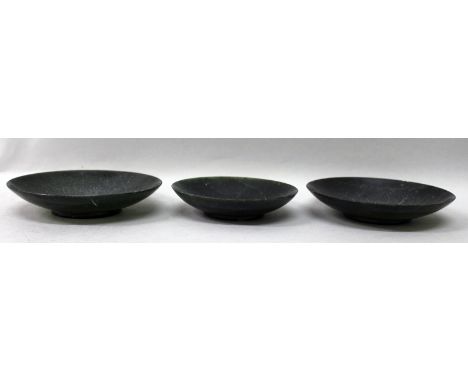 A GROUP OF THREE EARLY 20TH CENTURY CHINESE SPINACH JADE-LIKE SAUCERS, 4.7in diameter & smaller