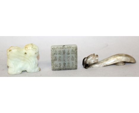 A CHINESE JADE BELT HOOK, of traditional form, 3.25in long; together with a celadon jade-like pendant model of a winged pixiu