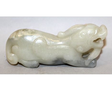 A CHINESE JADE MODEL OF A PIXIU, the winged mythical creature stretched forward with upraised head, the predominantly celadon