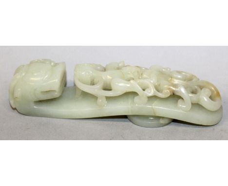 A CHINESE CELADON JADE BELT HOOK, of larger than average size and of traditional form, 5in long.