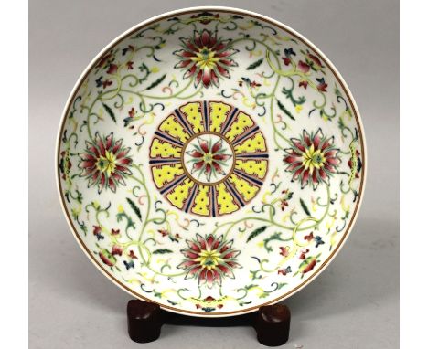 A CHINESE FAMILLE ROSE PORCELAIN SAUCER DISH, the interior painted with scrolling lotus, the base with a Jiaqing seal mark, 7