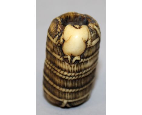 A JAPANESE MEIJI PERIOD CARVED IVORY NETSUKE OF A RAT & A ROPE BOUND BALE, the rat perched on the bale’s edge with it’s head 