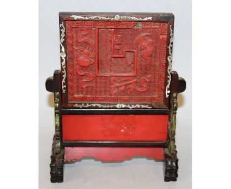 A 19TH CENTURY CHINESE RED CINNABAR LACQUER TABLE SCREEN, the two-section stand and screen panel contained in mother-of-pearl