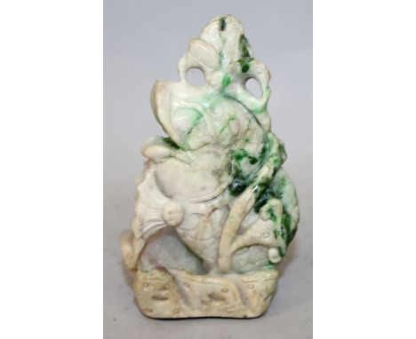 AN EARLY 20TH CENTURY CHINESE JADE MODEL OF A LEAPING CARP, leaping from waves amidst lotus, the stone of green and white hue