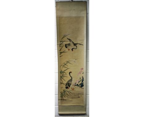 AN EARLY 20TH CENTURY CHINESE HANGING SCROLL PAINTING ON PAPER, with a silk surround, depicting two geese in a garden landsca