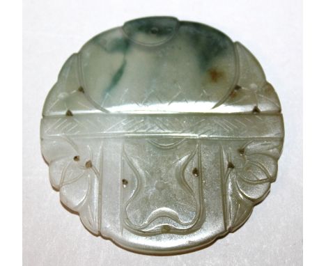 A 19TH/20TH CENTURY CHINESE SHAPED CIRCULAR JADE PENDANT, carved with designs of lotus, the predominantly white stone with br