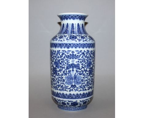 A CHINESE BLUE & WHITE PORCELAIN VASE, the steep sides decorated with bats supporting tasselled emblems amidst a ground of fo