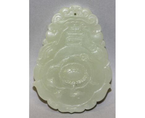 A CHINESE SHAPED CELADON JADE PENDANT, decorated to one side with a flowerhead, the reverse side with a seal mark, 3in high.