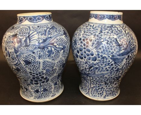 A GOOD NEAR LARGE PAIR OF CHINESE KANGXI PERIOD BLUE & WHITE PORCELAIN VASES, circa 1700, each painted with an overall design