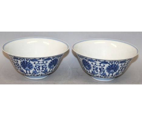 A PAIR OF GOOD QUALITY CHINESE BLUE & WHITE PORCELAIN BOWLS, each decorated with a formal design of scroll-stemmed lotus, eac