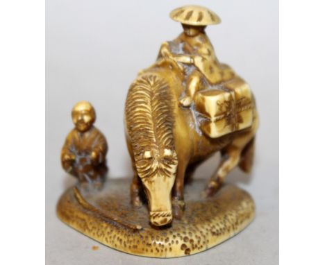 A SIGNED JAPANESE MEIJI PERIOD IVORY NETSUKE OF TWO TRAVELLERS, one seated on a horse, the base with engraved inscription and