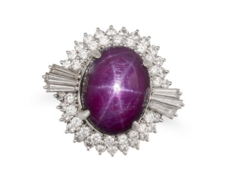 A STAR RUBY AND DIAMOND RING set with an oval cabochon star ruby of approximately 16.39 carats in a cluster of round brillian