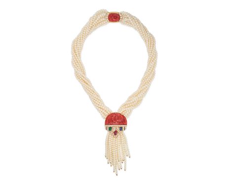 A MULTIGEM PEARL TASSEL NECKLACE / BROOCH comprising twelve rows of pearls, the central plaque set with a carved coral accent