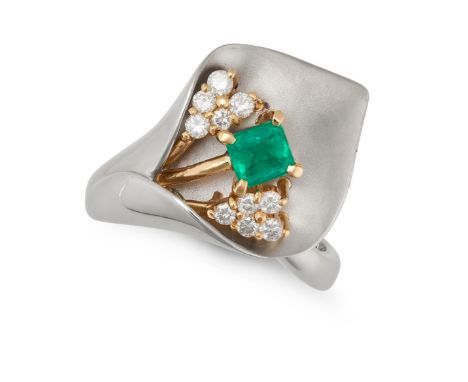 AN EMERALD AND DIAMOND LILY RING designed as a peace lily set with an octagonal step cut emerald and round brilliant cut diam