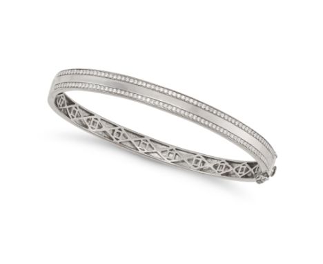A DIAMOND BANGLE in 18ct white gold, the hinged bangle set with two rows of round cut diamonds, full British hallmarks, inner