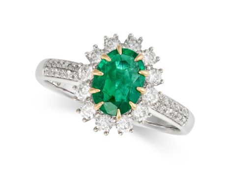 AN UNTREATED EMERALD AND DIAMOND CLUSTER RING set with an oval cut emerald of 1.25 carats in a cluster of round brilliant cut