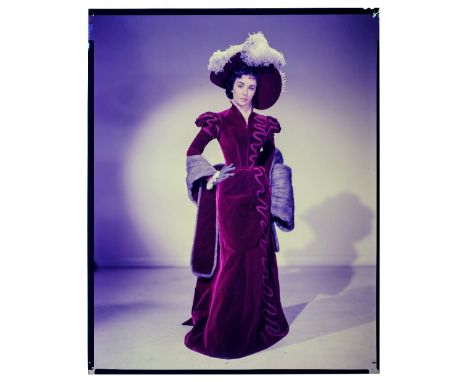 * Taylor (Elizabeth, 1932-2011). Full-length portrait of the young Elizabeth Taylor in red velvet dress with matching bonnet,