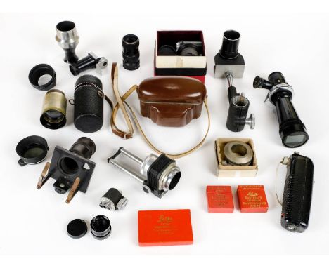 * Leica accessories. A collection of Leica accessories, comprising filters, lens caps, lens hoods, prism finder, magnifier, b