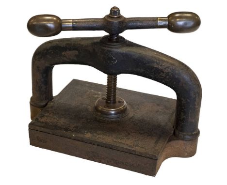 * Bookpress. A cast iron bookpress, finished in black, with brass handle ends, platen approximately 30 x 25.5cm (12 x 10 inch