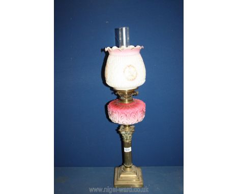A double burner Oil Lamp on Corinthian column with pink and white china reservoir and milk glass and pink shade, with chimney