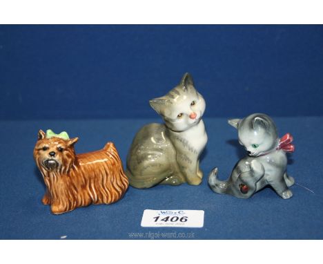 A small grey and white Beswick cat, West German kitten and Goebel Yorkshire Terrier with green bow.